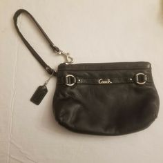 Coach Gallery Black Leather Medium Corner Zip Wristlet with Wrist Strap, Hangtag Coach Good Used Condition Black Leather Corner Zip Wristlet Gallery Medium Wristlet Approximate Measurements Height 5" Length 7" This Coach Gallery Black Leather Medium Wristlet is in good used condition, the wrist strap has some wear as noted in photos. This medium sized wristlet is made of soft black leather and has a corner zip closure. It is from the Coach gallery collection and it has silver tone hardware.  It Coach Leather Wristlet With Zipper Closure, Coach Wristlet With Wrist Strap For Travel, Formal Leather Wristlet, Formal Leather Wristlet With Wrist Strap, Leather Wristlet With Wrist Strap For Formal Occasions, Leather Formal Wristlet With Wrist Strap, Coach Wristlet With Wrist Strap For Daily Use, Everyday Coach Leather Wristlet, Black Leather Wristlet