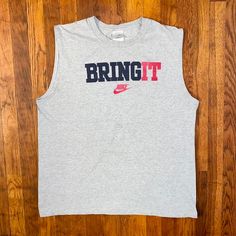 Dope tank top from the early '00s. Big spellout and logo on front. Has some faint staining on the "B" and "R" otherwise in good condition. Tagged an XL but fits more like a L.  Brand: Nike Size: L Color: Gray, Black, Red Condition: Good Tank T-shirt With Letter Print For Streetwear, Casual Sleeveless T-shirt With Logo Print, Y2k Style Cotton Crew Neck Tank Top, Y2k Style Crew Neck Cotton Tank Top, Y2k Crew Neck Cotton Tank Top, Y2k Cotton Crew Neck Tank Top, Cotton Tank Top With Logo Print, Cotton Letter Print Vest For Streetwear, Cotton Vest With Letter Print For Streetwear