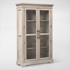 a white wooden cabinet with glass doors