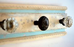 three knobs are attached to the wall in an old - fashioned style coat rack