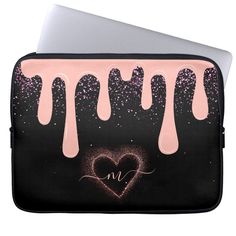 a laptop computer case with pink and black drips on the front, featuring a heart