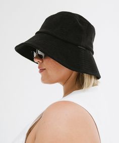 This bucket hat transitions seamlessly from the water to the street. Pair it with your favorite swimwear, a flowy sundress, or casual shorts + a tee for an effortlessly chic summer look! The oversized brim provides ample shade, protecting your face from the sun's harsh rays, while the relaxed fit ensures it stays comfortably in place without feeling too tight. Casual Short Brim Hat For Warm Weather, Black Summer Sun Hat, Casual Adjustable Hats For Warm Weather, Summer Sun Hat In Solid Color For Everyday, Chic Everyday Sun Hat With Short Brim, Chic Short Brim Sun Hat For Everyday, Lightweight Solid Color Casual Sun Hat, Black Bucket Hat With Upf 50+ For Summer, Everyday Lightweight Bucket Sun Hat