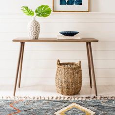 a table with a basket and vase on it