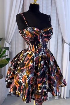 This chic party dress is super cute. Its a rare find African print Corset dress with lace up back. The Corseted waist gives an effect of a smaller waistline. FABRIC ON DISPLAY IS low in stock & may be  UNAVAILABLE at the time of order: send a message for fabric options.  Can be ordered as a gift Available for customization in different fabrics and sizes. This can be made with plain colored fabrics too.  Custom dresses and bespoke designs are acceptable, Kindly send pictures for personalized desi Pretty African Dresses, Ankara Summer Dresses Short, Wax Dress Styles, Cute African Print Dresses, Ankara Dress Short Styles, Nigerian Short Dresses, Party Dress With Corset Back And Fit And Flare, Party Fit And Flare Dress With Corset Back, Fit And Flare Party Dress With Corset Back