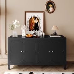 a black cabinet with two vases on top of it