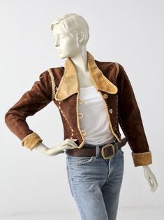 "This 1970s vintage, custom leather jacket has bold rock n' roll style. The rare find, was hand crafted and features whip-stitch and braid detailed seams. It fits cropped and fitted with slightly puffed shoulders. Dark brown suede shapes the jacket with yellow leather detailing on the big collar and rolled cuffs. Princess seams down the bust are detailed with cross-stitches. The jacket closes with 3 horn buttons, and opens to a fully lined interior. CONDITION In great condition with wear consist Fitted Retro Leather Jacket, Western Style Fitted Leather Jacket For Fall, Vintage Outerwear With Contrast Stitching For Fall, Fitted Retro Leather Jacket For Fall, Retro Fitted Leather Jacket For Fall, Western Style Fitted Leather Jacket For Winter, Vintage Winter Outerwear With Contrast Stitching, Fitted Western Leather Jacket For Winter, Vintage Outerwear With Contrast Stitching For Winter