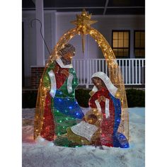 the nativity scene is made out of glass and decorated with lights, including a star