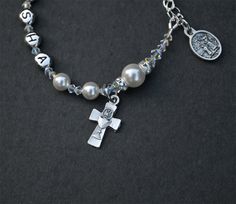 Personalized Custom Name First Holy Communion Swarovksi Sparkly White Crystal Pearl Rosary Bracelet Sterling Adjustable Sizing for Girls What girl wouldn't love to receive a beautiful Swarovski crystal pearl bracelet personalized with her own name to celebrate her First Holy Communion? The sterling silver extender chain allows the bracelet to grow with her, ensuring many years of wearability long after her special day. Each of the 6mm white crystal pearls represents a Hail Mary prayer. If you ch Silver Beaded Bracelets With Pearl Charm As Gift, Silver Bracelets With Pearl Charm As Gift, Personalized Silver Pearl Bracelet For Wedding, Personalized Silver Crystal Bracelet For Anniversary, Personalized Silver Crystal Bracelet For Gift, Silver Pearl Bracelet With Pearl Charm For Mother's Day, Personalized Silver Crystal Bracelet For Mother's Day, Silver Crystal Bracelet For Birthday And Mother's Day, Personalized Silver Pearl Bracelet For Anniversary