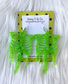 "You pick your glitter color LARGE skeleton earrings! Earrings hang from .925 solid sterling silver ear wires made in the USA. Size is approximately: 3.75\" Long and 1.75\" wide. See the glow in the dark style here: https://www.etsy.com/listing/864370661/glow-in-the-dark-skeleton-earrings-glow?ref=shop_home_active_1 I ship all earrings on various cardstock designs in 3 1/2\" x 3 1/2\" eco friendly reusable high quality jewelry boxes made in the US. I package up to 2 pairs in each box and tie eac Glitter Skeleton, Dark Skeleton, Candy Corn Earrings, Laser Projects, Skeleton Earrings, Dark Style, Earrings Halloween, Jewellery Box Making, Costume Earrings