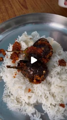 a plate with rice and meat on it