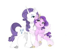 two pink and purple ponies standing next to each other in front of a white background