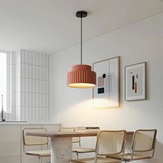 a table with chairs and a lamp hanging from it's ceiling in a white room