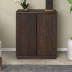 a tall wooden cabinet sitting next to a plant