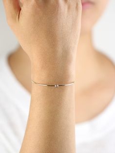 JSVConcepts Fine Jewelry Diamond Bangle Bracelet, Diamond Solitaire Bangle Bracelet, Minimalist Bracelet, 14K Gold Bangle Bracelet, Diamond Bracelet, Gift for her ≫ Product Details ◈ Handmade / Handcrafted Fine Jewelry ◈ Diamond: 100% Natural Diamond ◈ Diamond Weight: 0.07 ct. (2.60 mm) ◈ Color: G Color ◈ Clarity: VS-SI ◈ Cut: Brilliant Cut ◈ Bangle Thickness: 1.30 mm ◈ Metal: Solid 14K Gold (18K also available - Additional fees may apply) ◈ Gold Color: White gold, Rose gold, Yellow gold ≫ Pleas Minimalist White Gold Bracelet For Everyday, Minimalist White Gold Everyday Bracelet, Minimalist Everyday White Gold Bracelet, Gold Sterling Silver Bracelet For Anniversary, Gold Sterling Silver Bracelet For Anniversary, Minimalist Style, Minimalist 14k Gold Diamond Jubilee Bracelet, Delicate White Gold Bangle Bracelet, Adjustable Minimalist Sterling Silver Bracelet In Yellow Gold, Adjustable Yellow Gold Sterling Silver Minimalist Bracelet