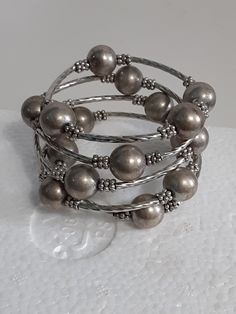 Very good condition Beaded Multi-strand Metal Bracelets, Elegant Multi-strand Silver Beads Bracelet, Adjustable Gray Metal Jewelry, Elegant Gray Bracelet, Elegant Gray Round Bead Bracelets, Elegant Gray Round Beads Bracelets, Elegant Gray Bracelet Jewelry, Bohemian Silver Wrap Bracelet With Spacer Beads, Stackable Beaded Bracelets With Round Metal Beads