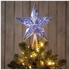 a lighted christmas tree topper in the shape of a star