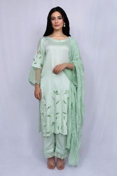 Mint green kurta with floral cutwork and sheer sleeve hem detailing. Paired with tonal pant and kota dupatta.
Component: 3
Type Of Work: Floral
Neckline: Round
Sleeve Type: Full sleeves
Fabric: Modal Satin, Kota, Organza
Color: Green
Other Details: 
Sheer sleeve hem
Nalki work or neckline
Scallop hem on kurta
Occasion: Puja - Aza Fashions Summer Silk Sets With Sheer Dupatta, Summer Silk Sharara With Sheer Dupatta, Green Floral Embroidered Cotton Silk Dupatta, Spring Cotton Silk Sharara With Straight Kurta, Designer Cotton Silk Palazzo Set For Spring, Summer Chanderi Kurta With Sheer Dupatta, Cotton Silk Sharara With Straight Kurta For Spring, Spring Chanderi Sharara, Spring Designer Cotton Silk Palazzo Set