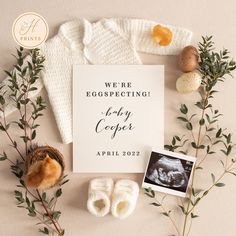 a baby announcement card surrounded by other items