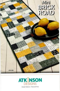 a table runner with lemons on it and the words atk inson designs