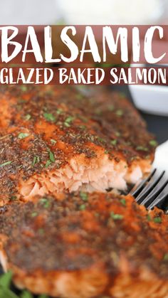 a piece of salmon is on a plate with a fork and seasoning next to it