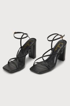 The Lulus Makennaa Black Strappy High Heel Ankle Strap Sandals are the perfect finishing touch to any flirty going-out look! These sleek heels have a smooth faux leather construction that shapes a square toe bed, a slender toe strap, and matching vamp straps that create a crisscrossing effect. An adjustable ankle strap sprouts from the sides and secures with a shiny gold buckle, all atop a chic block heel. 3. 75" wrapped block heel. Cushioned insole. Rubber sole has nonskid markings. Man made ma Trendy Ankle Strap Heels With Wrapped Heel, Trendy Heels With Ankle Strap And Wrapped Heel, Date Night Heels With Wrapped Block Heel, Chic Ankle Strap Synthetic Heels, Chic Ankle Strap Heels In Synthetic Material, Chic Synthetic Ankle Strap Heels, Trendy Evening Block Heels With Wrapped Heel, Sleek Heels With Heel Strap And Block Heel, Sleek Ankle Strap Heels For Date Night