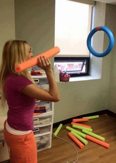 the girl is playing with her toys in the room, and she's trying to play with them