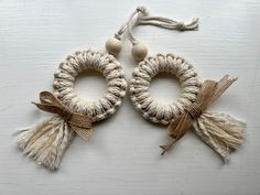 two small wreaths with tassels on them