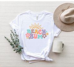 "Beach Bum Shirt, Cute Beach Shirt, Beach Bum Tee, Funny Beach T-Shirt, Summer Shirts, Summer Vacation Tee, Girls Beach Shirt, Sun Shirt ☀️☀️☀️☀️☀️ Everything in our shop is hand crafted and made to order. If you want different color or size contact me! If you would like something custom made to fit your personal style please message me and I will do everything to get you that something special. ---How To Order--- ⭐️Please, check and review all photos ⭐️Choose your t-shirt size and color ⭐️Enter Funny Beach, Beach Humor, Girls Beach, Beach T Shirt, Shirts Summer, Sun Shirt, Custom Printed Shirts, Beach T Shirts, Beach Shirt