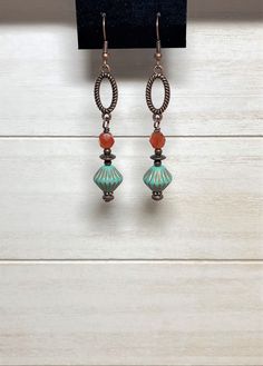 "Long boho dangle earrings created using Czech glass bicone beads in matte turquoise with etched copper accents, burnt orange Czech fire polish glass beads, small copper beads, and spacer beads.  These are wire-wrapped to antique copper oval connectors.  Total length of earrings, including the ear wire, is approximately 2-1/2\". Matching necklace: https://www.etsy.com/listing/1519124092/beaded-bohemian-necklace-with-copper?click_key=5b35150b8614b4eac85f62531910e6638ba2c2a0%3A1519124092&click_sum Bohemian Czech Glass Crystal Earrings Nickel Free, Bohemian Czech Glass Earrings With Ear Wire, Bohemian Nickel Free Czech Glass Earrings, Bohemian Crystal Earrings With Adjustable Czech Glass, Bohemian Czech Glass Crystal Earrings Adjustable, Bohemian Nickel-free Czech Glass Earrings, Bohemian Crystal Earrings With Adjustable Fit, Bohemian Czech Glass Dangle Earrings, Bohemian Czech Glass Drop Earrings