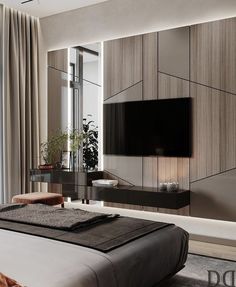 a bedroom with a large tv mounted on the wall above it's headboard