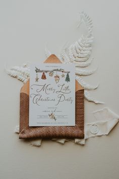 the wedding stationery is laid out on top of some white paper and twine