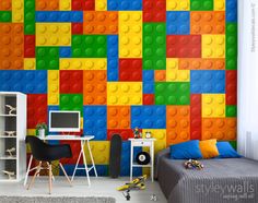 a bedroom with lego themed wallpaper and a bed in front of the computer desk