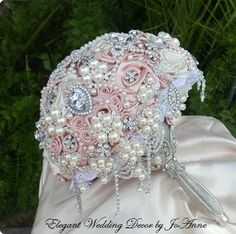 a bridal bouquet with pink roses and pearls