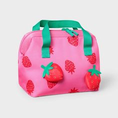 a pink lunch bag with strawberries on it