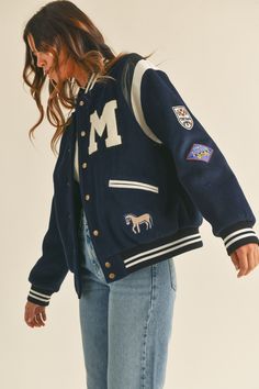 Stay warm and stylish in this M Bomber Varsity Jacket. Crafted with a long sleeve fit, this jacket features cute patches and embroidery detail for a unique look. The quilted inside adds an extra level of warmth and comfort, while the premium quality ensures it stands the test of time Jersey Jacket Outfit, Varsity Jacket Outfit Women, Varsity Outfit, Varsity Jacket Style, Vintage Varsity Jacket, Senior Jackets, Varsity Jacket Outfit, Varsity Jacket Women, Leather Varsity Jackets