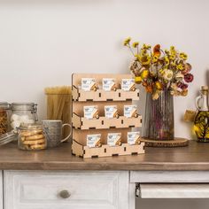 a table topped with lots of boxes filled with cookies next to a vase full of flowers