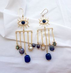 Chunky Evil Eye Long Statement Dangle Earrings, Chandelier Lapis Earrings, Boho Style Gold Brass Earrings  Why these earrings can be a perfect gift for your loved one or you? - Comes in great packaging, with a re usable storage box & a silk pouch.  - Perfect for all occasions. - You can add a personal message to your order.  To make your purchase a special gift for your friend or family, you can choose from our pre made relationship cards.  PLEASE SELECT THE RELATIONSHIP CARD WHILE CHECKING OUT. FOR REFERENCE GO THROUGH THE LAST IMAGE OF THE LISTING.  Specifications -  Gemstone  - Natural Lapis, Labradorite, Pearl  Length  - 4 inches approx  Find the best pair of earrings for your beautiful ears here -  https://www.etsy.com/shop/TheEnache?ref=seller-platform-mcnav&section_id=28306680 ** IM Lapis Earrings, Earrings Chandelier, Gold Brass, Earrings Boho, Brass Earrings, Chandelier Earrings, Boho Earrings, Personal Message, Statement Jewelry