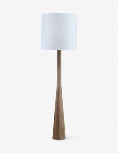 a wooden table lamp with a white shade on the top and bottom part of it