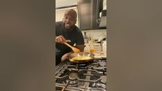 a man is cooking in a skillet on the stove