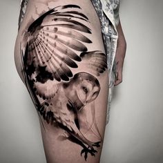 a woman's thigh with an owl tattoo design on her leg and the lower half of her thighs