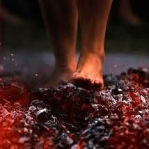 a close up of a person's bare feet standing on top of crushed food