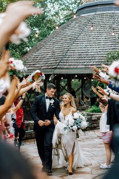 the bride and groom are walking down the aisle