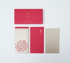 red and white greeting cards with envelopes on the bottom left hand side, in front of two smaller ones