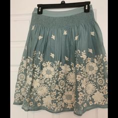 Beautiful Embroidery Skirt With Zipper On The Side. Very Beautiful Details And 60% Silk And 40% Cotton Spring Embroidered Skirted Bottoms, Embroidered Skirted Bottoms For Spring, Casual Embroidered Mini Skirt For Spring, Casual Floral Embroidery Skirt, Casual Summer Mini Skirt With Floral Embroidery, Casual Blue Skirt With Floral Embroidery, Spring Embroidered Midi Skirt, Spring Embroidered Flared Skirt, Casual Embroidered Tiered Skirt