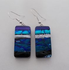 I fused 2 layers of glass to create this gorgeous earring ,,dichroic glass and clear glass on the top. The size is 1/2" by 1 " .All my jewelry come in a nice gift box. Silver Czech Glass Earrings As Gift, Silver Czech Glass Earrings For Gift, Iridescent Ear Wire Earrings For Gift, Czech Glass Rectangular Earrings For Gift, Rectangular Czech Glass Earrings For Gifts, Clear Glass Earrings As A Gift, Clear Glass Earrings For Gifts, Clear Glass Earrings For Gift, Iridescent Czech Glass Earrings For Gift