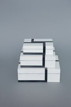 four white boxes stacked on top of each other with black and white lines in the middle