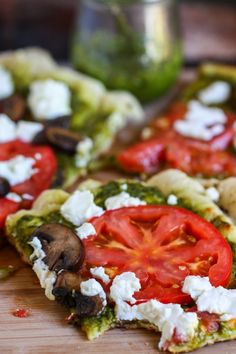 there are several slices of pizza with tomatoes and mushrooms on it, along with other toppings