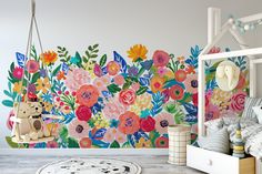 a child's room with flowers painted on the wall and a swing in the foreground