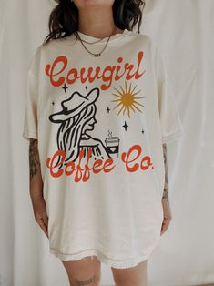 Cowgirl Coffee Co Tee – We The Babes Comfortable Graphic Print T-shirt, Casual Coffee-colored Screen Print T-shirt, Coffee Color Short Sleeve T-shirt With Screen Print, Trendy Oversized T-shirt With Front Print, Trendy Relaxed Fit T-shirt For Loungewear, Comfortable Graphic Print T-shirt For Streetwear, Vintage Crew Neck T-shirt For Loungewear, White Retro T-shirt For Loungewear, Casual Relaxed Fit T-shirt In Ring-spun Cotton