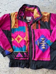 Vintage 90s Womens Nylon Jacket Size Medium See pics for measurements Colorful Southwest Design Shoulder pads Fine condition Fast shipping. We ship same or next day with USPS mail We are a small family business and we appreciate your purchase, Godspeed ! 90s Style Multicolor Windbreaker For Spring, Retro Multicolor Windbreaker For Fall, Vintage Multicolor Windbreaker For Fall, 90s Patchwork Multicolor Outerwear, 90s Style Multicolor Patchwork Outerwear, 90s Style Multicolor Windbreaker For Outdoor, 90s Multicolor Windbreaker For Outdoor, Retro Pink Windbreaker For Fall, 90s Multicolor Outdoor Outerwear